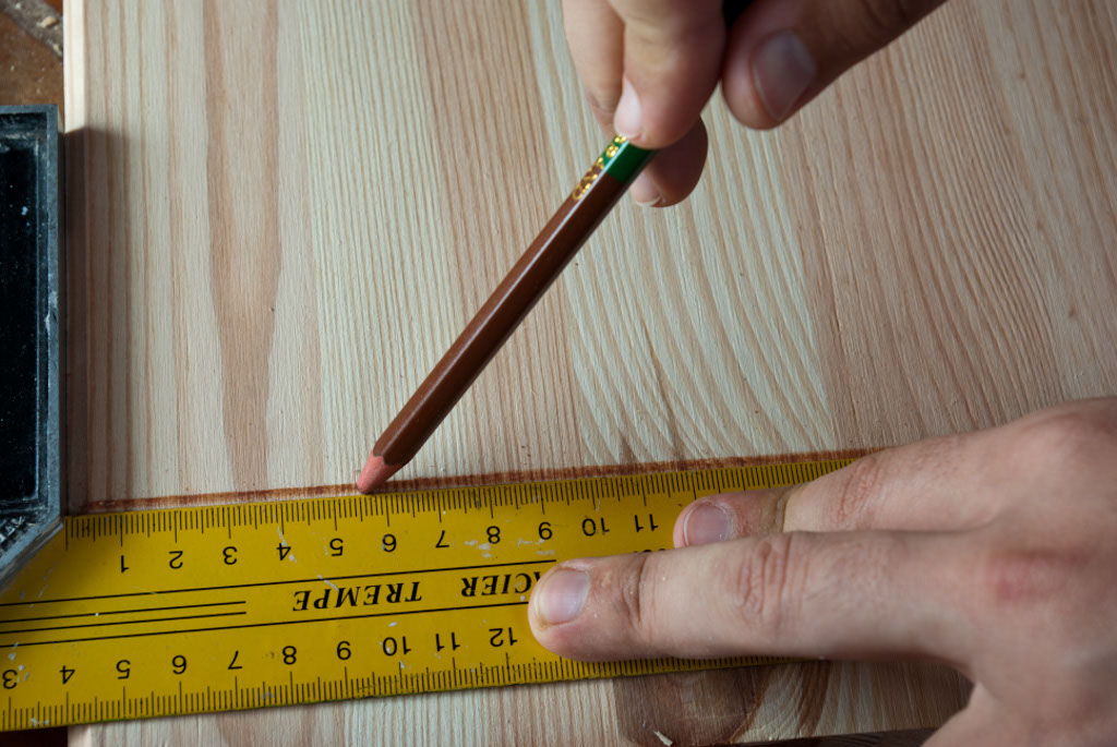 Measuring the shelf space on a wood board