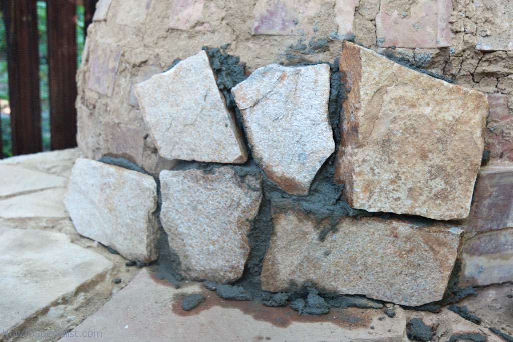 Covering the pizza oven with stone