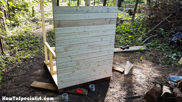Attaching-the-slats-to-the-back-of-the-outhouse