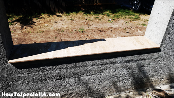 Fitting-the-travertine-capings-to-the-concrete-fence-base