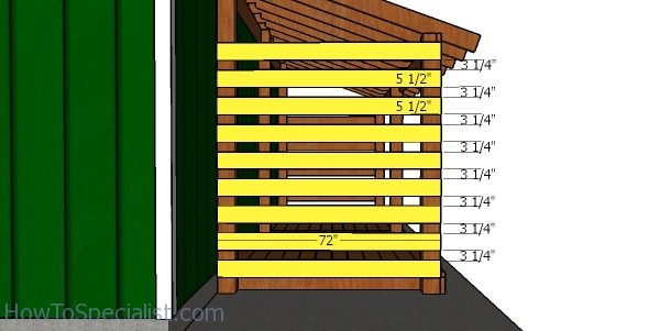 Fitting the slats to the sides of the wood shed