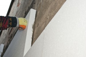 Installing polystyrene boards to concrete wall