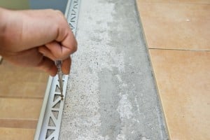 Securing metal tile edging with screws