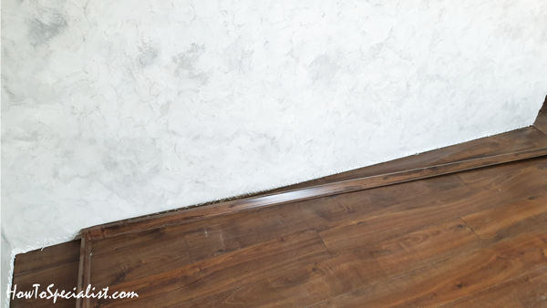 Baseboard-trims-with-glue-on-crooked-walls