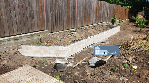 Concrete-flower-bed-with-travertine